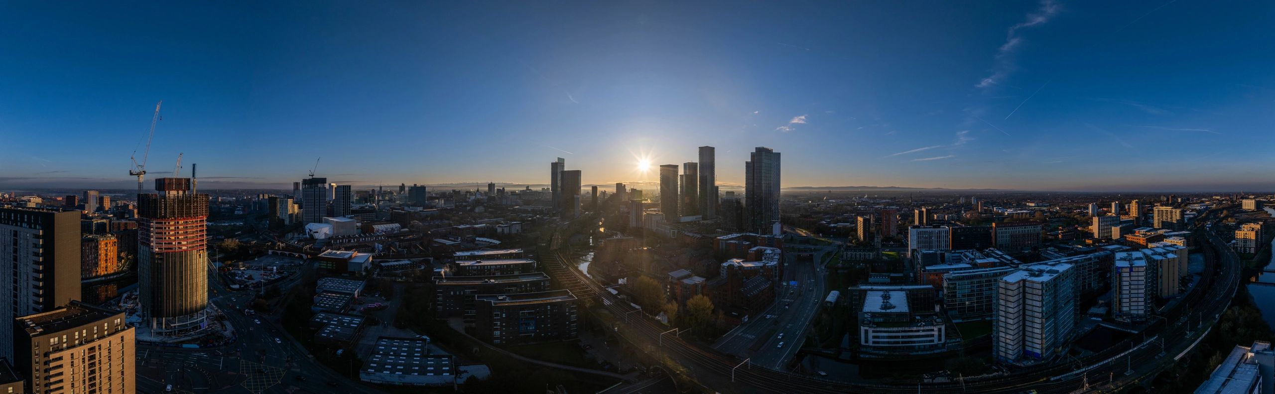 Modern city skyline at sunrise representing long-term planning