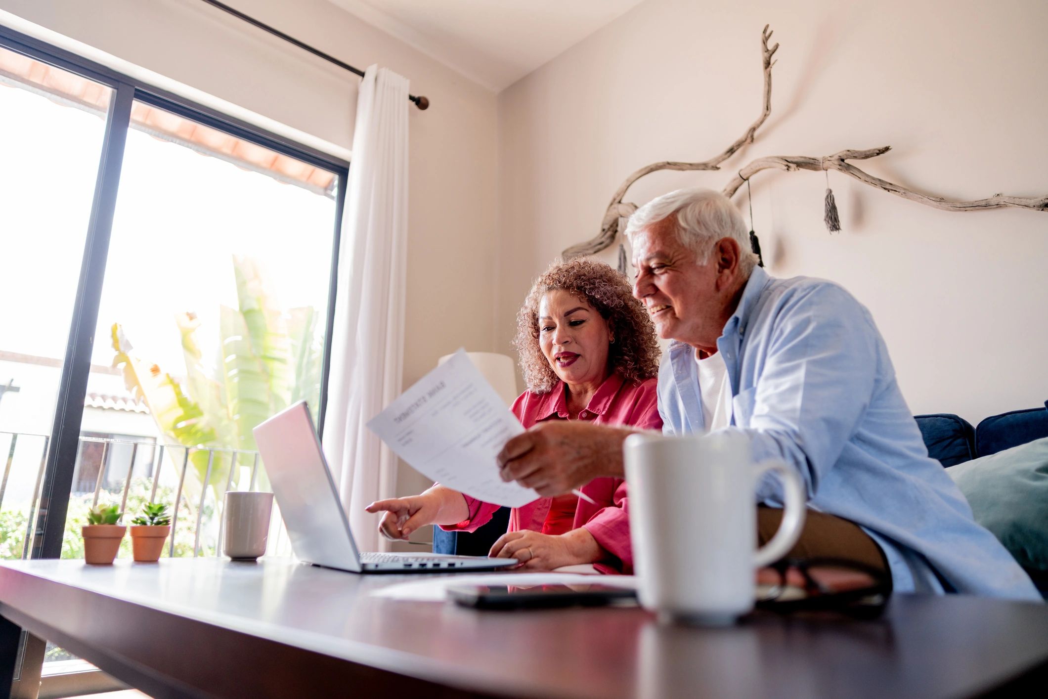 Senior couple reviewing finances together at home