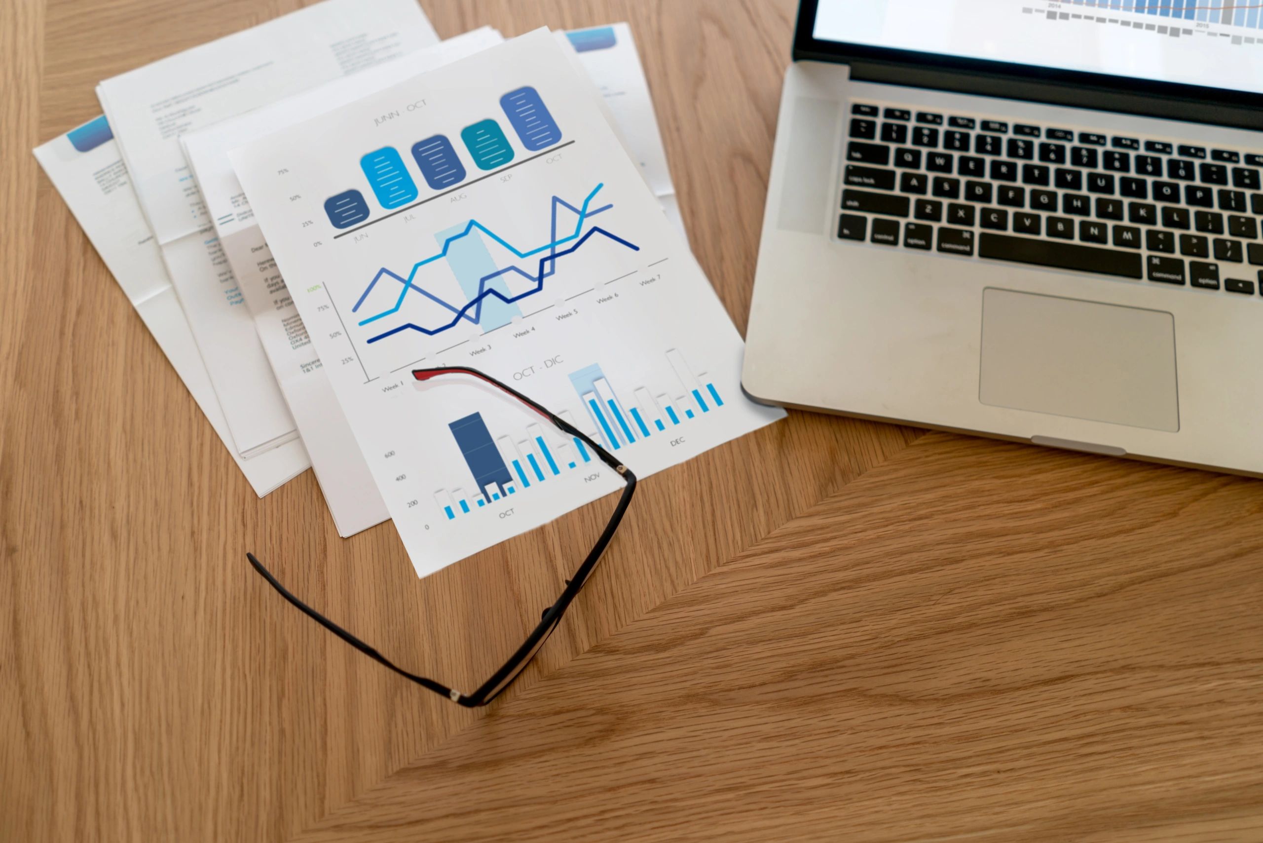 Financial documents and laptop on a desk